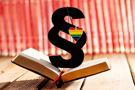 Wooden paragraph symbol of law and justice with heart in lgbt rainbow colours. Lgbt rights and lawの写真素材