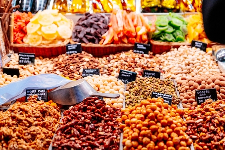 Dried fruits and sweets on market stall in La Boqueria, Barcelona