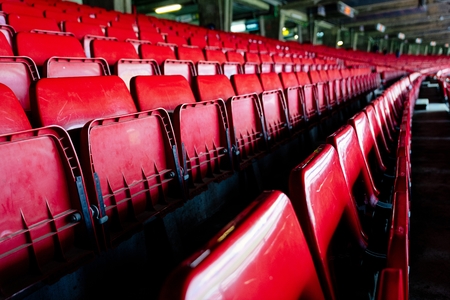 Red plastic empty stadium seats. Football stadiumの写真素材