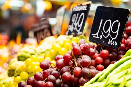 Green and purple grapes on vegetable and fruits market stall for saleの写真素材