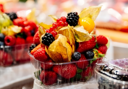 Healthy fruit lunch takeaway. Fresh fruits in plastic basketの写真素材