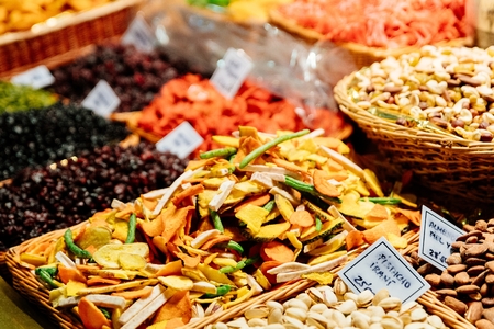 Dried fruits, pistachio nuts and other fruits and vegetables on market stallの写真素材