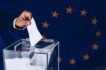 Elections to the European Parliament. EU elections. Man throwing his vote into the ballot box.の写真素材