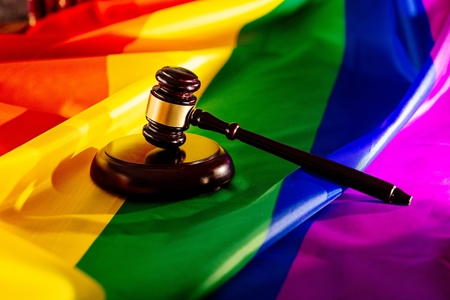 Wooden judge mallet on lgbt rainbow flag. Law and lgbtの写真素材