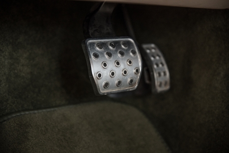 Metal brake and acceleration pedal in car with automatic gearbox. Modern car interior
