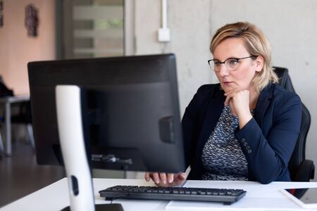 40 years old middle aged woman working in officeの写真素材