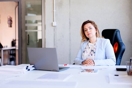 40 years old woman clerk working in the officeの写真素材