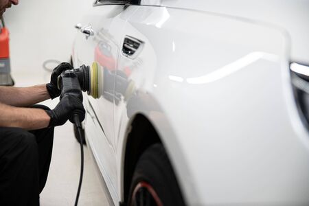 Polishing car with electric grinder. Removing scratches from paintの写真素材