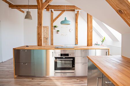 Bright attic kitchen in the loft apartmentの写真素材