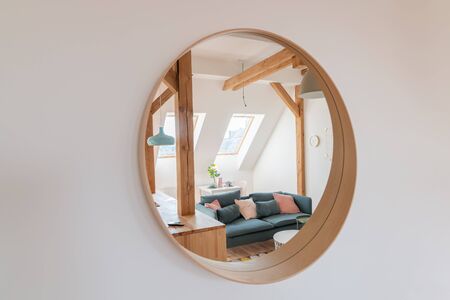 Round mirror on the living room wallの写真素材