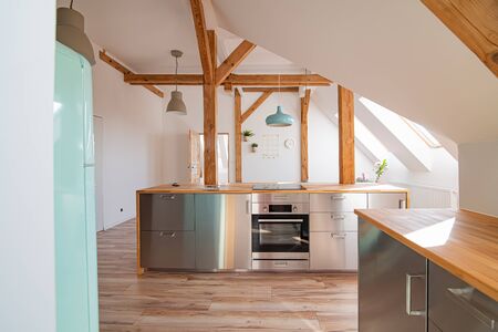 Modern attic white bright kitchen in the loft apartmentの写真素材