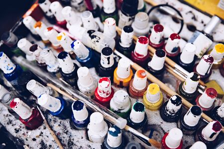 Dirty paint containers and brushes. Artist palette. Top viewの写真素材
