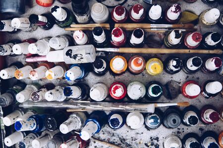 Dirty paint containers and brushes. Artist palette. Top viewの写真素材