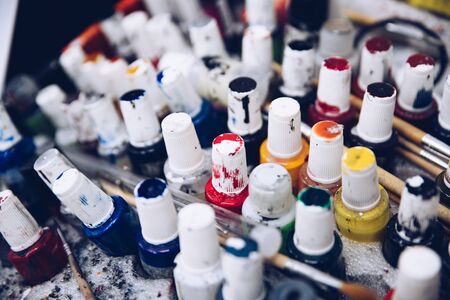 Dirty paint containers and paintbrushes. Paint colors palette. Top viewの写真素材