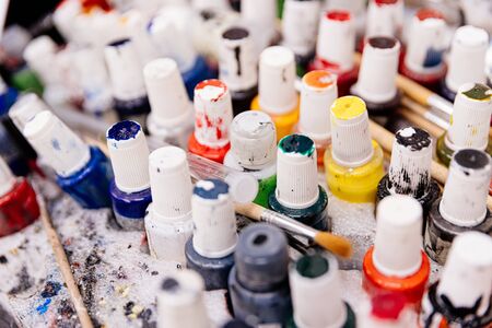 Dirty paint containers and paintbrushes. Paint colors palette.の写真素材