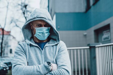 Man wearing medical protective mask during coronavirus covid-19 pandemicの写真素材