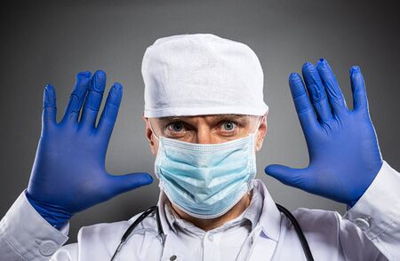 Man medic wearing protective medical mask. Covid-19 preventionの写真素材