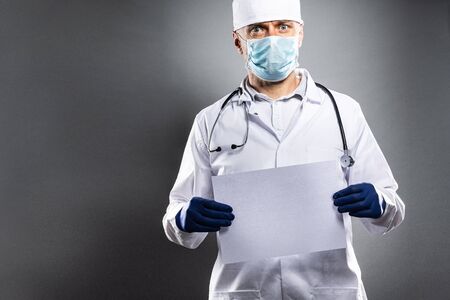 Man doctor holding empty card with space for message