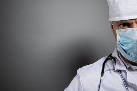 Close up on doctors face in medical protective maskの写真素材