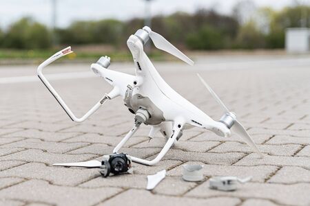 Crashed modern drone and camera after drone accident