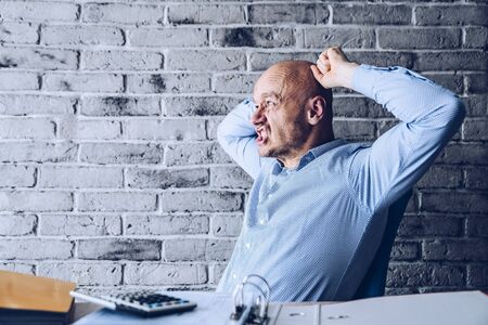 Worried confused man in shirt working in the officeの写真素材