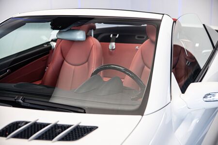 Luxury convertible car with red leather seats