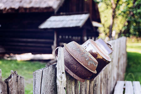 Polish countryside. Old clay pots on an old wooden fence.の写真素材