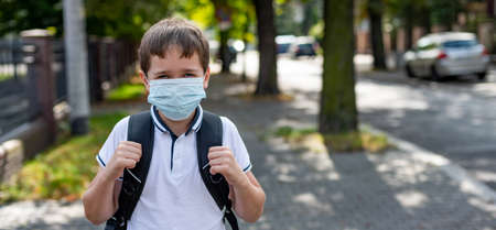 Boy in mask going to school in medical mask.の写真素材