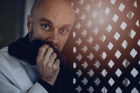 Priest vicar in confession booth.