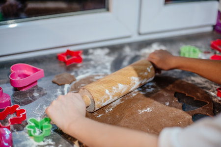 Young girl is making Christmas gingerbread dough.の写真素材