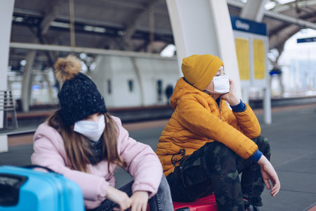 During the pandemic, bored and sad children want to go on winter holidays.の写真素材