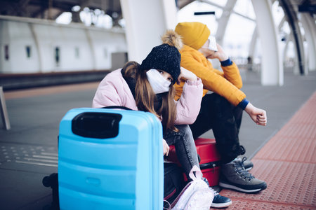 During the pandemic, bored and sad children want to go on winter holidays.の写真素材