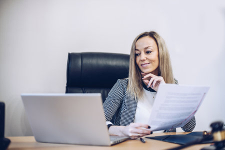 Smiling female notary working in her office.の写真素材