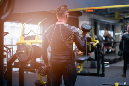 Male athlete is working out at the gym in front of the mirror.の写真素材