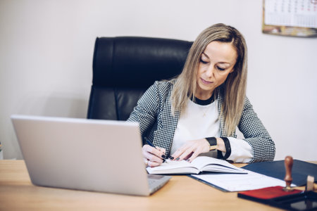 A notary, a woman lawyer works in her office, records appointments.の写真素材