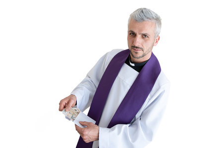 Polish catholic priest holding Polish money zloty during pastoral visit in Polandの写真素材