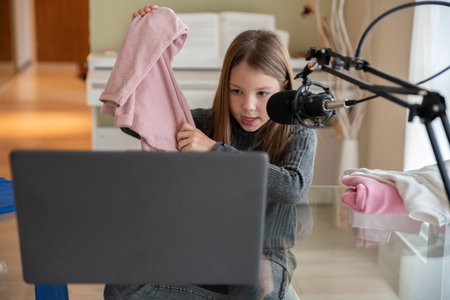 Young beautiful girl recording video for her blog about clothes.の写真素材