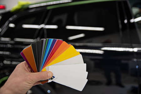 Man choosing color of his car with color sampler.の写真素材