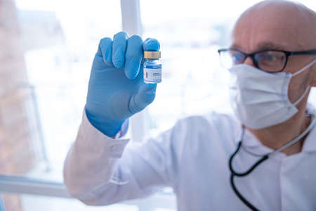 COVID-19 Coronavirus Vaccine. Doctor scientist analyzing virus.