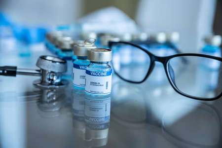 Medicine with vaccine on covid-19 and syringe with needle.の写真素材