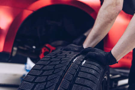 Changing car tire and wheel in the car mechanical service