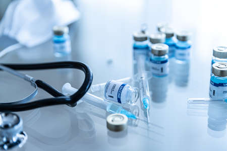 Coronavirus COVID-19 vaccine in ampoules. Vials and Syringe.の写真素材
