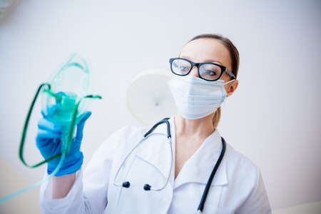 Doctor puts on oxygen mask. Emeregency and first aid concept.の写真素材