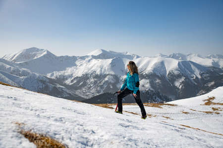 Female woman tourist in the mountains goes along the trail.の写真素材
