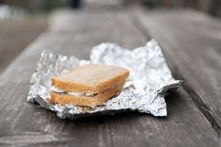 Sandwich on aluminum foil for breakfast on the outdoor trip.の写真素材