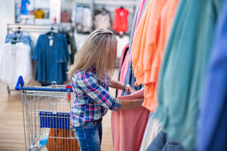 Woman while shopping in a clothing department store or supermarket.の写真素材