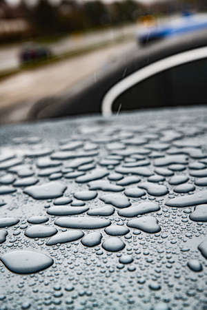 Rain drops on car paint threated with hydrophobic coating.の写真素材