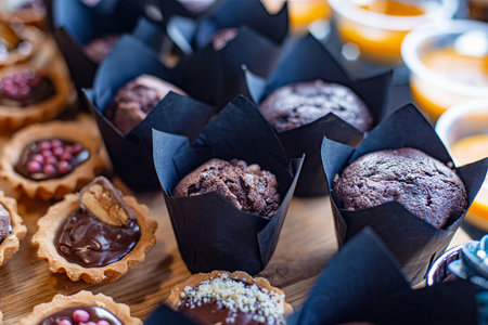 Chocolate cupcakes with choclate sprinkles and colorful dragees.の写真素材