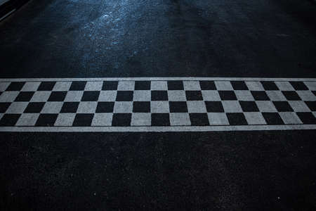 Race finish line on black asphaltの写真素材