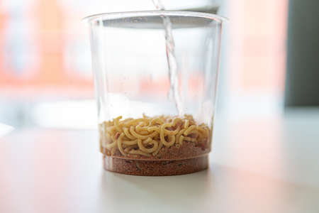 A cup of instant soup or pasta.の写真素材